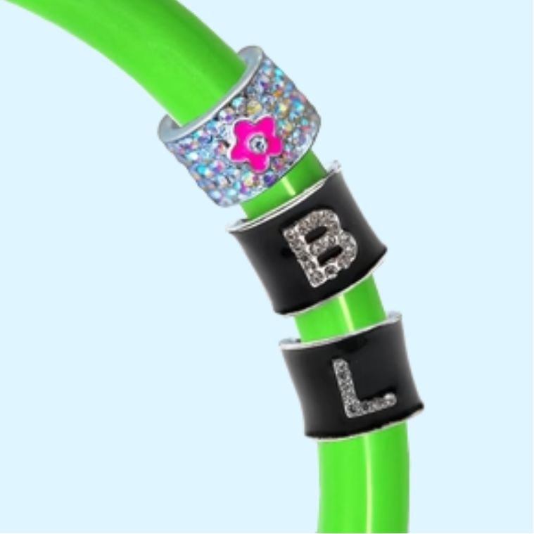 Green stethoscope tubing with decorative stethoscope charms featuring letter monograms and a flower design