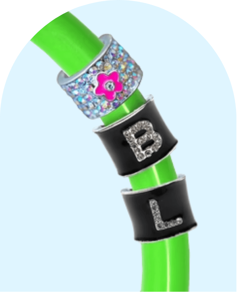 Green stethoscope tubing with decorative stethoscope charms featuring letter monograms and a flower design