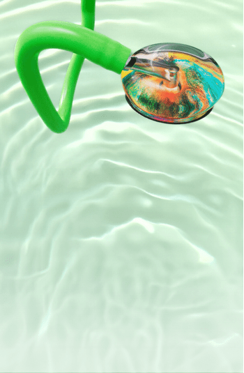 Close-up of a stethoscope with green tubing with a colorful head design